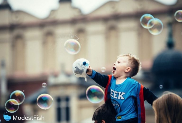 Boy having a great time playing with giant bubbles